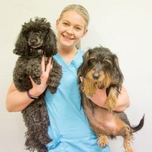 Emily Harrison holding two dogs.
